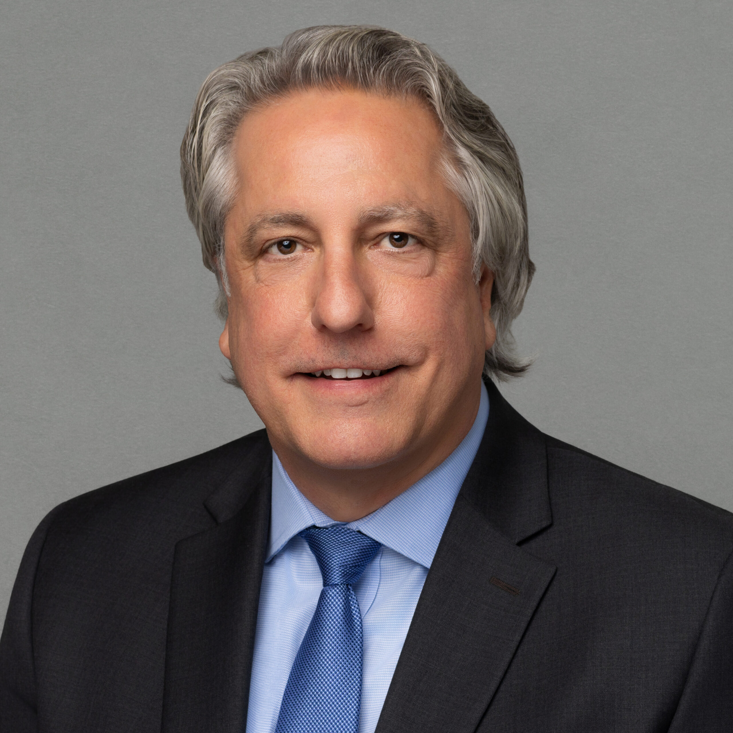 Picture of a man smiling for a professional photo.