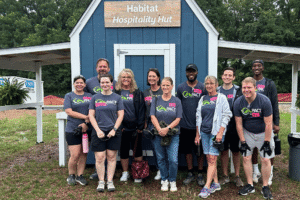 Group of Merchants Bank employees standing in front of a barn after a volunteer event.