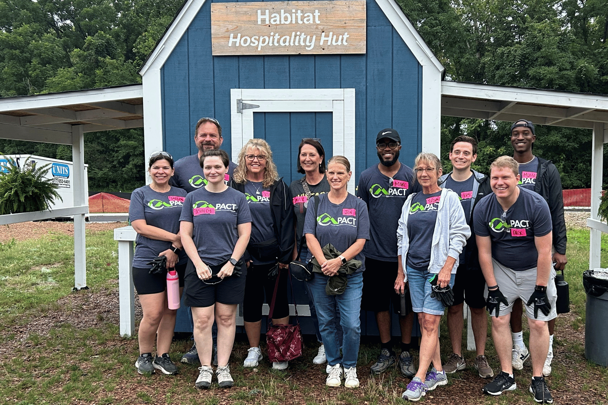 Group of Merchants Bank employees standing in front of a barn after a volunteer event.